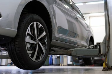 Moscow Russia - January 2022: A modern car in a car service on a lift awaits repair or service. Selected focus.