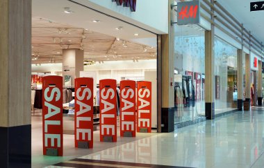 Moscow Russia - January 2022: Bright banners with the inscription SALE at the entrance to the store. Seasonal sales of products at discounted prices.