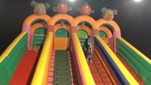 Group Children Enjoying Colorful Slide Slipping Park Night Bright Electric — Stock Video