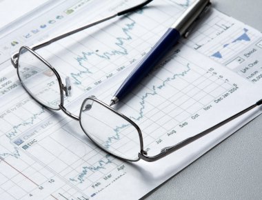 Pen, business chart and glasses