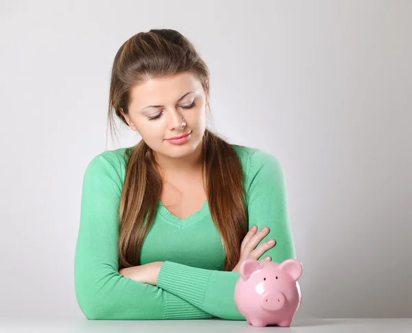 Young beautiful woman with piggy bank Royalty Free Stock Images