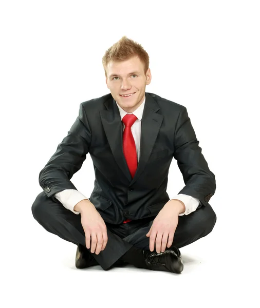 Расслабленный бизнесмен, сидящий на полу — стоковое фото
