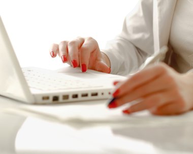A young businesswoman working on a laptop clipart