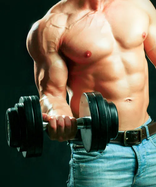 Muscular man working out with dumbbells — Stock Photo, Image