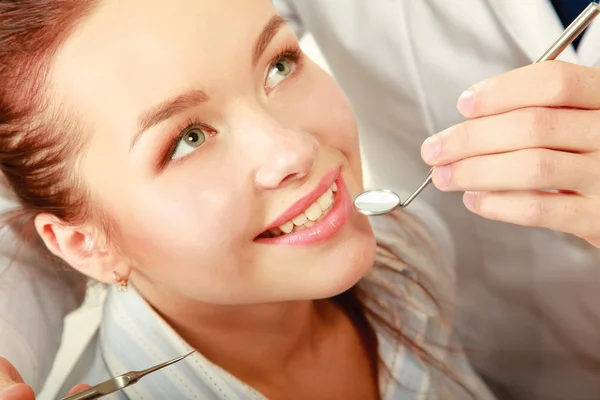 Ung kvinna med tandläkare i en tandläkarmottagning. — Stockfoto