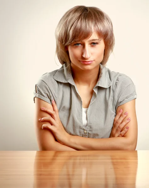 Cansado jovem mulher sentada na mesa — Fotografia de Stock