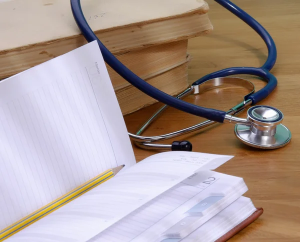 Stethoscope with reference books — Stock Photo, Image