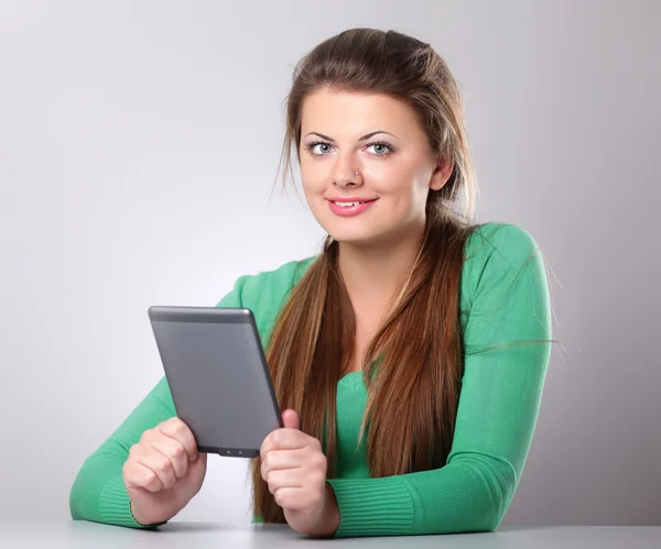 Woman sitting holding computer plane-table — Stock Photo, Image
