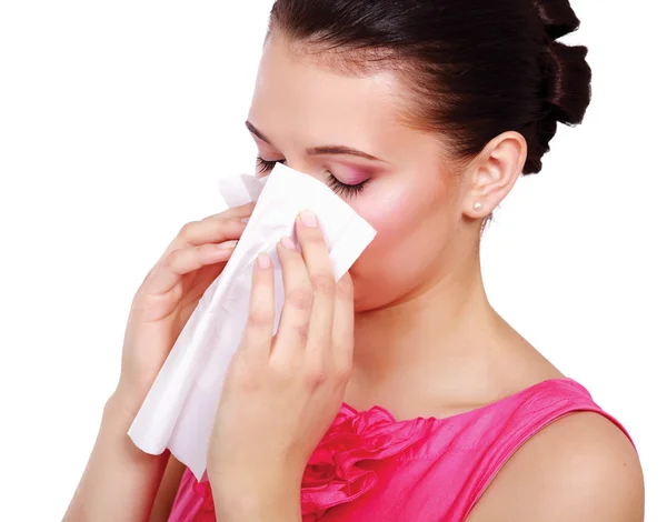 A portrait of a young woman blowing her nose — Stock Photo, Image
