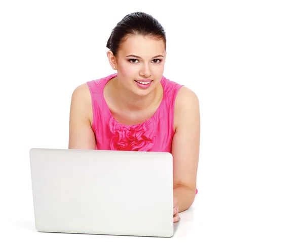 Beautiful young woman lying on floor with a laptop — Stock Photo, Image