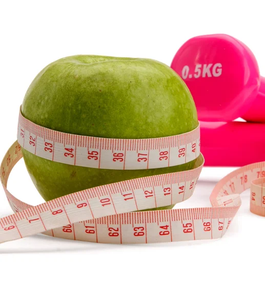 An apple, a measuring tape and dumbbell — Stock Photo, Image