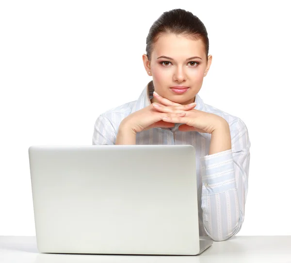 A young woman sitting with a laptop Royalty Free Stock Images