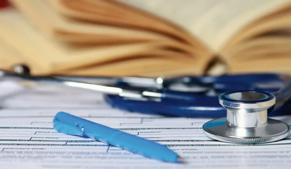 A stethoscope is lying with a book — Stock Photo, Image