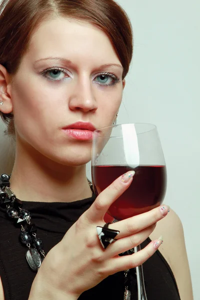Vrouw met een wijnglas over de muur — Stockfoto