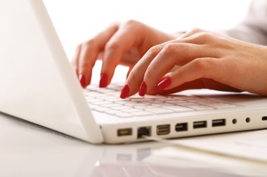 Female hands working on a laptop clipart