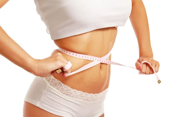 A slim girl measuring her waist — Stock Photo, Image