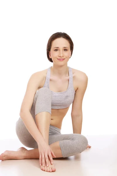 A young sportive girl sitting — Stock Photo, Image