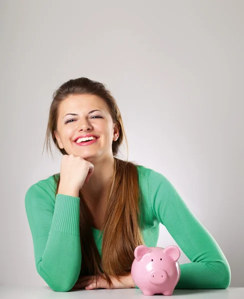 Young beautiful woman with piggy bank — Stock Photo, Image