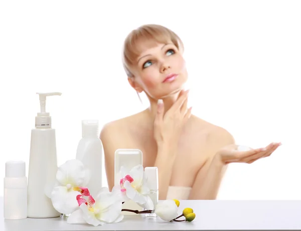 A young woman applying cream — Stock Photo, Image