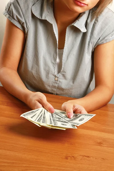 A young woman holding dollars — Stock Photo, Image