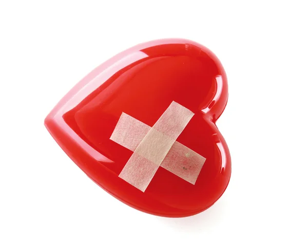 A red heart with adhesive plaster — Stock Photo, Image