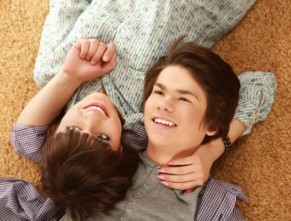 Young couple lying on floor — Stock Photo, Image