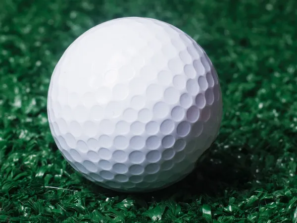 Golf ball ower green grass. — Stock Photo, Image