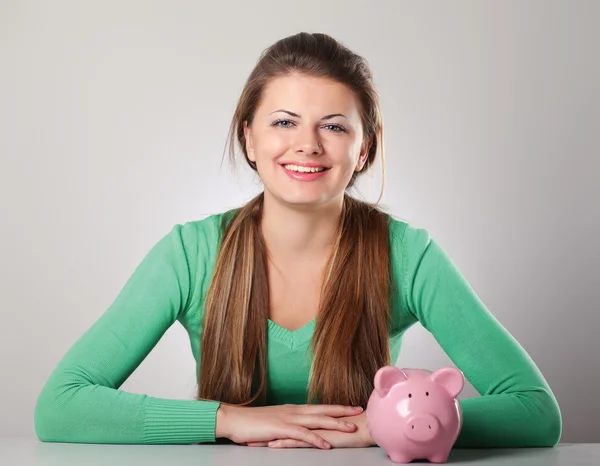 Beautiful woman with piggy bank — Stock Photo, Image