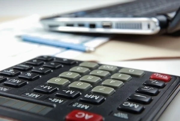 Calculator, pen, folder with documents, laptop. — Stock Photo, Image