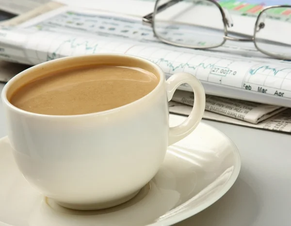 Cup of coffee near press — Stock Photo, Image