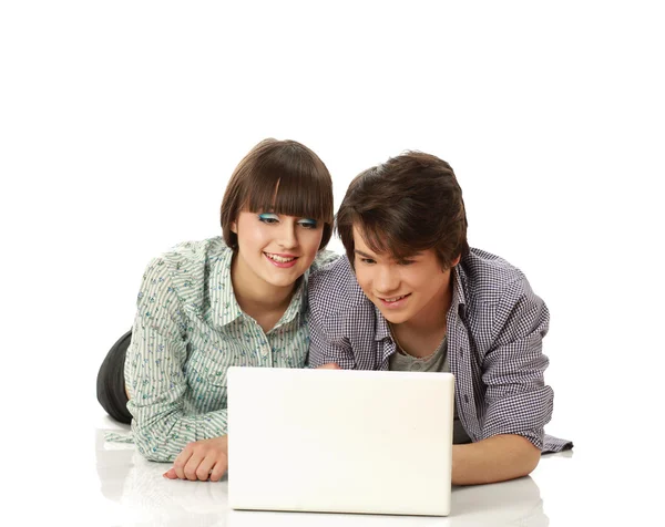Paar liegt auf dem Boden hinter Laptop — Stockfoto