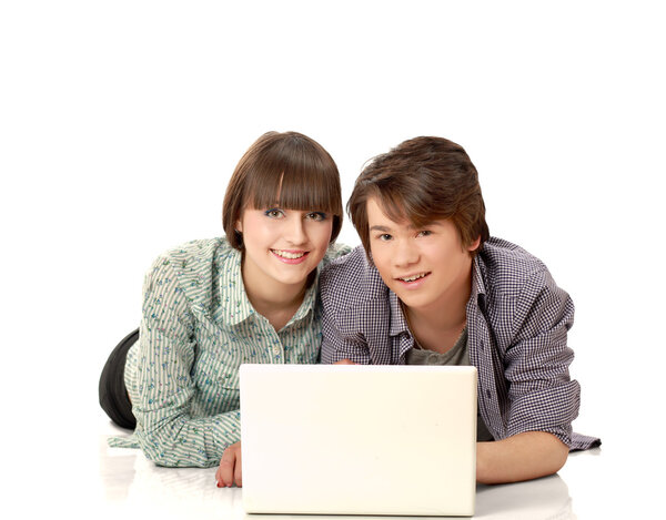 Couple lying on the floor behind a laptop
