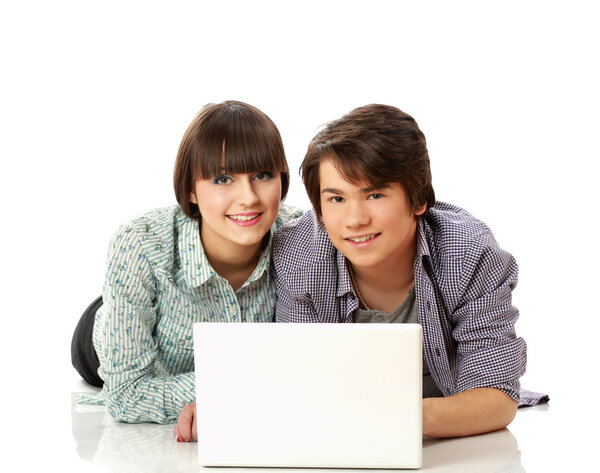 Couple lying on the floor behind a laptop
