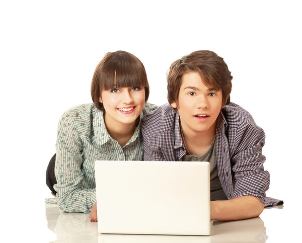 Couple lying on the floor behind a laptop