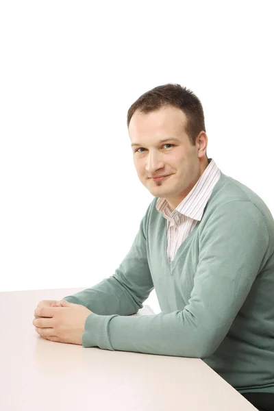 A young man sitting at table — Stock Photo, Image