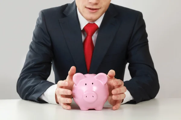 Young man with piggy bank — Stock Photo, Image