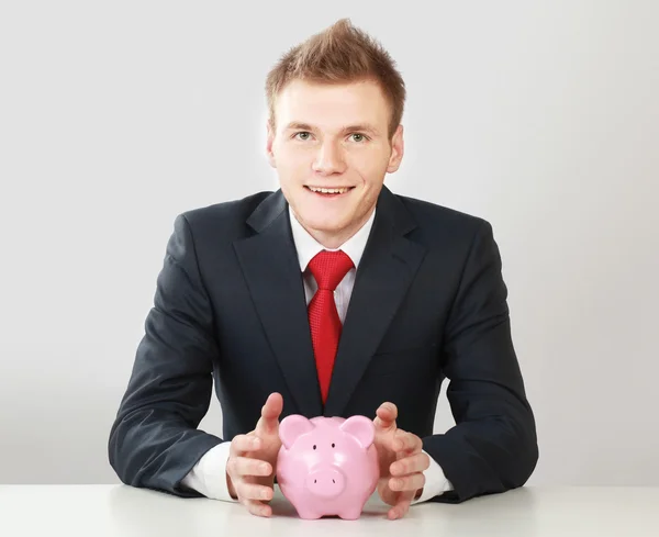 Young man with piggy bank — Stock Photo, Image