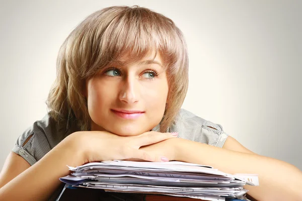 A young woman sitting at the desk — Stock Photo, Image