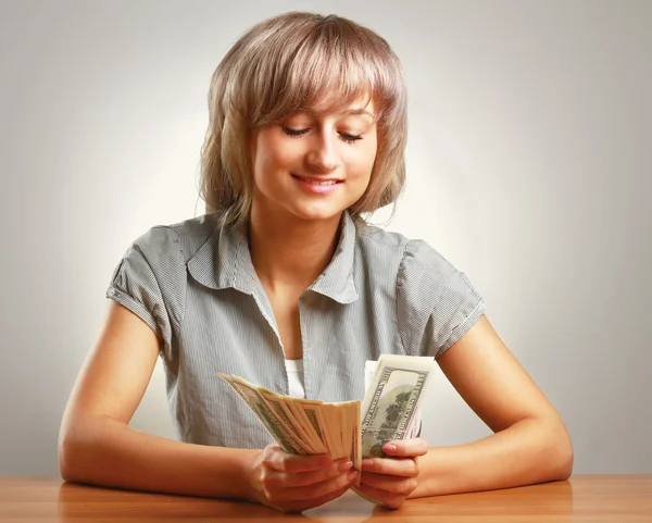 A young woman holding dollars — Stock Photo, Image