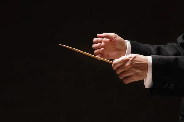 Concert conductor's hands with a baton — Stock Photo, Image