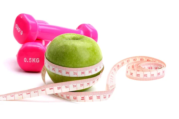 An apple, a measuring tape and dunbbell — Stock Photo, Image