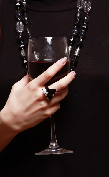 A wineglass in female hands — Stock Photo, Image