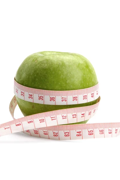 A green apple and a measurement tape — Stock Photo, Image