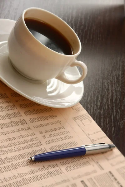 Cup of coffee near press — Stock Photo, Image