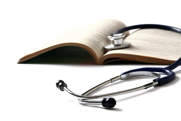 A stethoscope on an open book — Stock Photo, Image