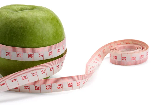 A green apple and a measuring tape — Stock Photo, Image