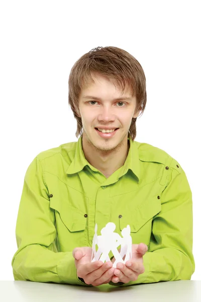 A young guy taking care of paper people — Stock Photo, Image