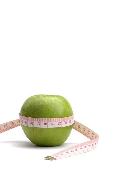 A green apple and a measuring tape — Stock Photo, Image