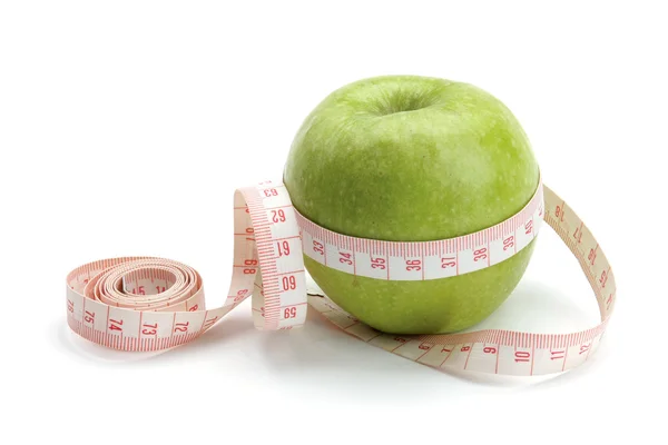 A green apple and a measuring tape — Stock Photo, Image