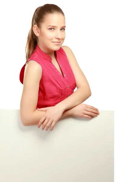 A smiling woman standing near blank — Stock Photo, Image